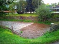 Water runs in the spring channel in a small town